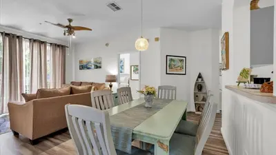 a dining room and living room with a table and a couch at Orlando Condo 6420: Family-Friendly Resort Near Disney in Kissimmee