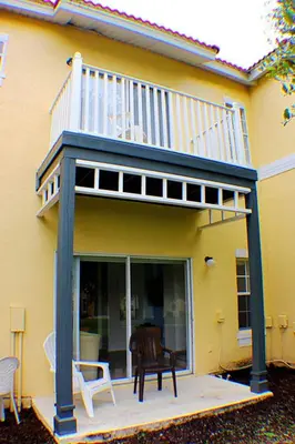 a deck on a house with a balcony at 5-Star Orlando Townhome 6423 - Resort Amenities Near Disney in Kissimmee