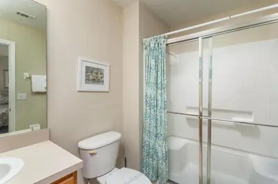a bathroom with a toilet and a glass shower at Orlando 6424 Townhome: Family Fun Close to Disney in Kissimmee