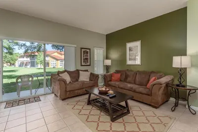 a living room with a couch and a table at Orlando 6424 Townhome: Family Fun Close to Disney in Kissimmee