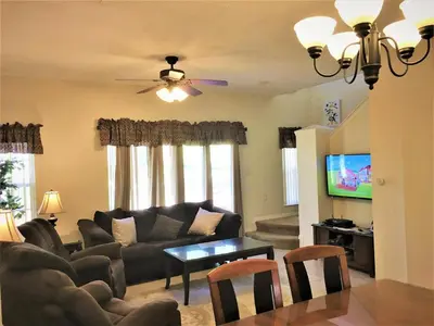 a living room with a couch and a table at Luxury Orlando Townhome 6425 - Emerald Island Resort Stay in Kissimmee