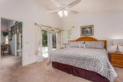 a bedroom with a bed and a ceiling fan at Orlando Villa 6426: Cumbrian Lakes Pool Spa Retreat in Kissimmee