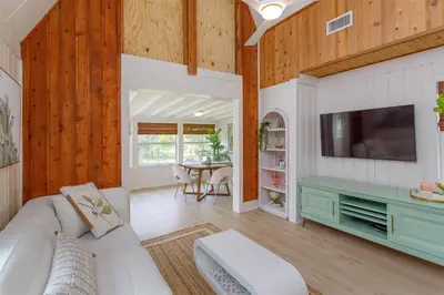 a living room with a couch and a tv at Orlando Home 6430: Purpose-Driven A-Frame Vacation Home in Clermont