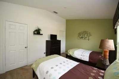 a bedroom with two beds and a dresser at Orlando Townhome 6436: Family Fun Near Disney World in Orlando