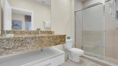 a bathroom with a sink and a toilet and a shower at Book Now: Orlando Townhome 6440 Near Disney Magic in Orlando