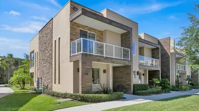 a large brick house with a balcony at Book Now: Orlando Townhome 6440 Near Disney Magic in Orlando