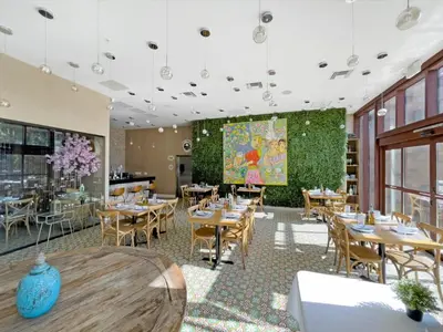 a restaurant with tables and chairs and a large screen at Book Now: Orlando Townhome 6440 Near Disney Magic in Orlando
