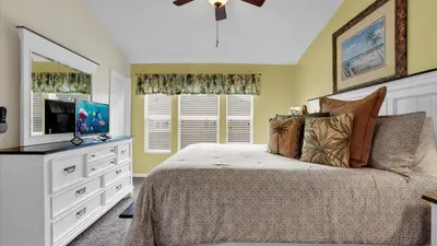 a bedroom with a bed with a dresser and a television at Orlando Townhome 6443: Family Fun Near Disney in Orlando