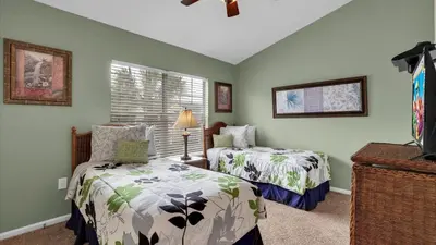 two beds in a room with green walls at Orlando Townhome 6443: Family Fun Near Disney in Orlando