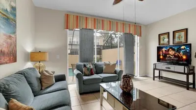 a living room with a couch and a tv at Orlando Townhome 6443: Family Fun Near Disney in Orlando