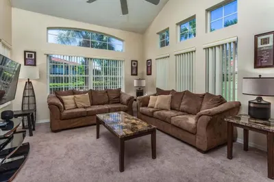 a living room with two couches and a table at Stay Near Disney at Orlando Townhome 6444 Sleeps 8 in Kissimmee