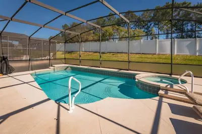 a swimming pool with a pergola on a house at Orlando Villa 6449: Experience Magic and Relaxation in Kissimmee