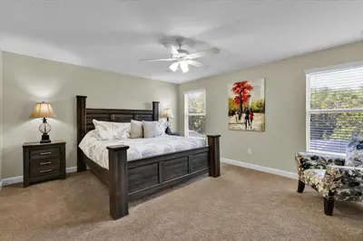 a bedroom with a bed and a ceiling fan at 5-Star Orlando Villa 6452: Family Fun Resort Access in Kissimmee