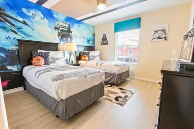 a bedroom with two beds and a painting on the wall at Orlando Townhome 6453: Your Private Pool Getaway in Kissimmee