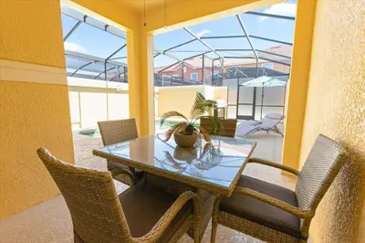 a dining room with a table and chairs at Orlando Townhome 6453: Your Private Pool Getaway in Kissimmee