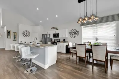 a kitchen and dining room with a table and chairs at Orlando Villa 6469: 6BR Home Near Disney Parks in Kissimmee