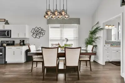 a kitchen and dining room with a table and chairs at Orlando Villa 6469: 6BR Home Near Disney Parks in Kissimmee