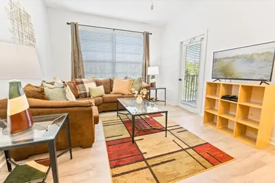 a living room with a couch and a tv at Orlando Condo 6470 - 3BR Family Getaway in Kissimmee