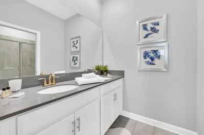 a white bathroom with a sink and a mirror at You and Your Family will Love this Luxury Villa on Storey Lake Resort Orlando Villa 6295 in Kissimmee