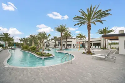 a swimming pool with palm trees in a resort at Orlando Villa 6401 - Dream Stay at Paradiso Resort in Orlando
