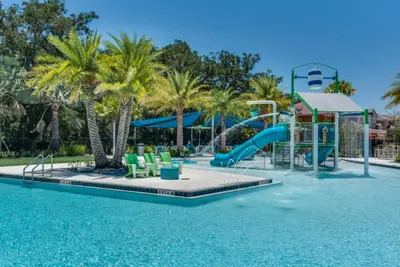 a pool with a water park with a slide at Picture Renting Your Own Luxury Villa on the Exclusive Paradiso Grande Resort close to Disney Orlando Villa 6402 in Orlando