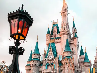 a castle in the background with a street light at Picture Renting Your Own Luxury Villa on the Exclusive Paradiso Grande Resort close to Disney Orlando Villa 6402 in Orlando