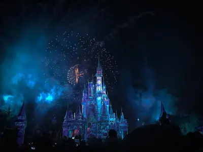 a disney castle with fireworks at night at Imagine Your Family Renting This Luxury Contemporary Style Villa on Paradiso Grande Resor Orlando Villa 6403 in Orlando