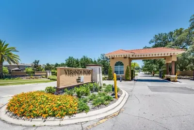 a sign for a hotel with flowers in the street at The Secret to Enjoying the Best Orlando Villa Holiday while Staying on Paradiso Grande Resort Orlando Villa 6409 in Orlando