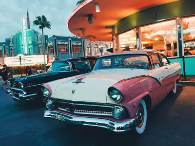 two old cars parked in front of a store at The Secret to Enjoying the Best Orlando Villa Holiday while Staying on Paradiso Grande Resort Orlando Villa 6409 in Orlando