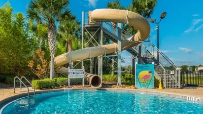 a swimming pool with a water slide in a resort at Orlando Villa 6394 - Premium Villa at Windsor Hills in Orlando