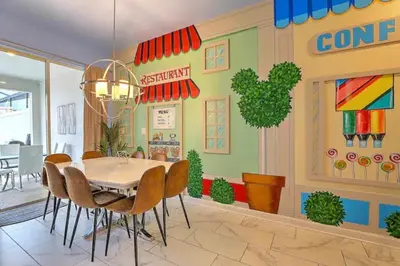 a dining room with a table and chairs at Orlando Villa 6227: The Secret to Your Dream Resort Holiday in Kissimmee