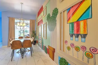 a dining room with a table and a colorful wall at Orlando Villa 6227: The Secret to Your Dream Resort Holiday in Kissimmee