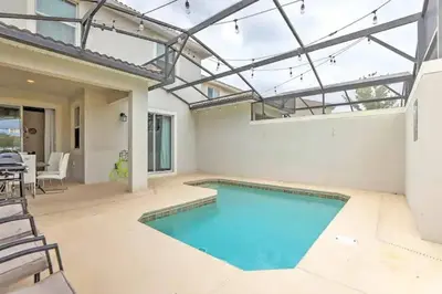 a swimming pool in a house with a glass ceiling at Orlando Villa 6227: The Secret to Your Dream Resort Holiday in Kissimmee