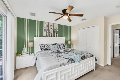 a bedroom with a bed and a ceiling fan at Orlando Villa 6230: A Stylish Family Retreat Near Disney in Kissimmee