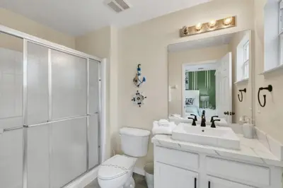 a bathroom with a toilet and a sink and a shower at Orlando Villa 6230: A Stylish Family Retreat Near Disney in Kissimmee