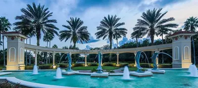 a swimming pool with water fountains and palm trees at Orlando Villa 6230: A Stylish Family Retreat Near Disney in Kissimmee