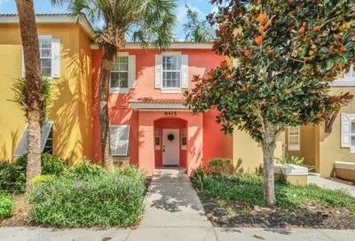 a orange and yellow house with trees in front of it at Orlando Villa 6230: A Stylish Family Retreat Near Disney in Kissimmee