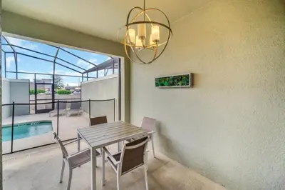 a dining room with a table and a chandelier at Experience Luxury at Orlando Villa 6231 Storey Lake in Kissimmee