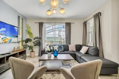 a living room with a couch and a table at Experience Luxury at Orlando Villa 6231 Storey Lake in Kissimmee
