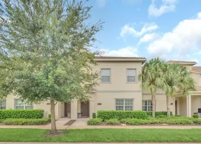 a house with two palm trees in front of it at Rent Orlando Villa 6235: Perfect Luxury Villa by Disney in Kissimmee