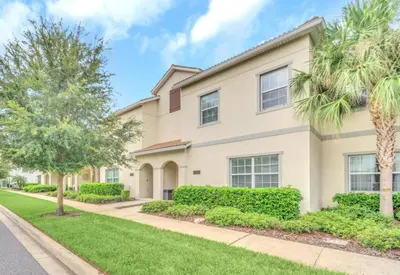 a house with palm trees and a sidewalk at Rent Orlando Villa 6235: Perfect Luxury Villa by Disney in Kissimmee