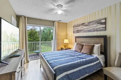 a bedroom with a bed and a balcony at Orlando Villa 6244: Luxury 5-Star Villa Minutes from Disney in Kissimmee