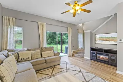 a living room with a couch and a ceiling fan at Orlando Villa 6244: Luxury 5-Star Villa Minutes from Disney in Kissimmee
