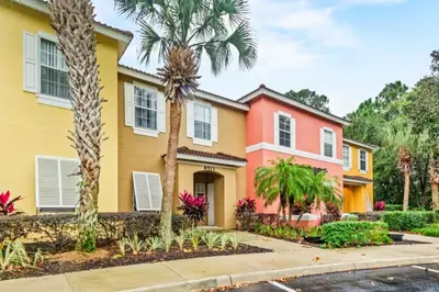 a house with palm trees in front of it at Orlando Villa 6244: Luxury 5-Star Villa Minutes from Disney in Kissimmee