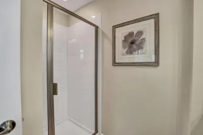 a shower with a glass door in a bathroom at Orlando Villa 6243: The Best Orlando Getaway at Storey Lake in Kissimmee
