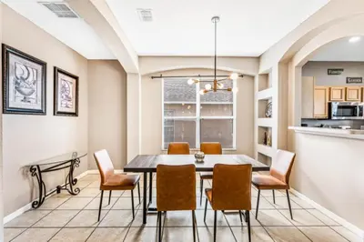 a dining room with a table and chairs at Orlando Villa 6245: Dream Holiday Villa in Emerald Island in Kissimmee