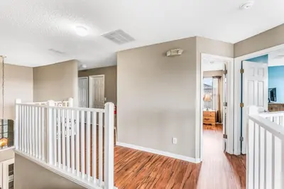 a staircase in a home with white railings at Orlando Villa 6245: Dream Holiday Villa in Emerald Island in Kissimmee