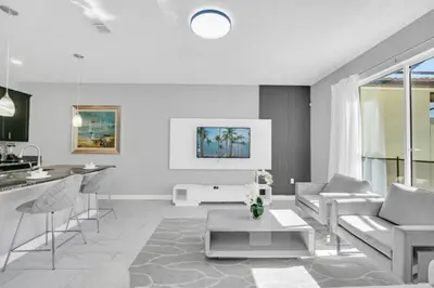 a living room with a couch and a table at Orlando Villa 6247: Relax in Style at Storey Lake Resort in Kissimmee