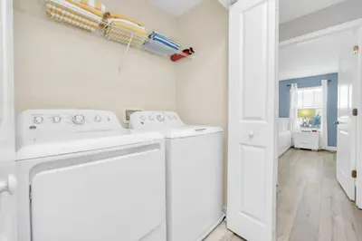 a white laundry room with a washer and dryer at Orlando Villa 6247: Relax in Style at Storey Lake Resort in Kissimmee