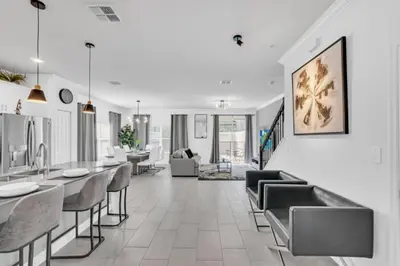 a dining room with chairs and tables in a building at Luxury Villa at Storey Lake Resort Near Disney – Orlando Villa 6253 in Kissimmee
